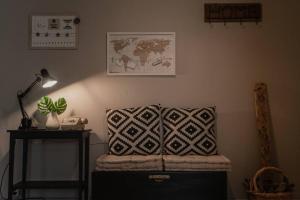 a room with a couch and a lamp and a table at Aigli's Urban Lodge in Volos