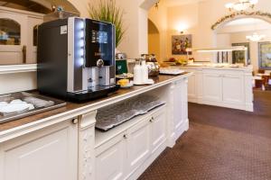 a kitchen with a counter with a coffee maker on it at Spa Hotel Anglický Dvůr in Karlovy Vary