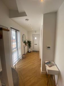 a room with a hallway with a table and a mirror at Whitstable Townhouse by the Sea in Whitstable