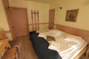 a bedroom with a bed with two books on it at La Ferma Veche Bogdana in Bogdana