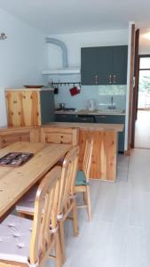 a kitchen with a long wooden table and chairs at Casa vacanza Terry a Sella Nevea in Sella Nevea