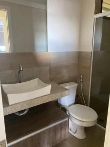 a bathroom with a sink and a toilet at Maceió Pajuçara Ed. Neo 1 in Maceió