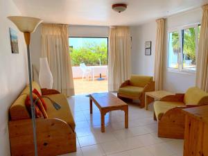 a living room with a couch and a table at Apartamentos Tamarindos in Puerto del Carmen