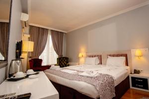 Postel nebo postele na pokoji v ubytování SRF Hotel