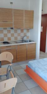 a kitchen with a sink and a bed in a room at Elena Club Resort in Silvi Marina