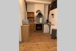 a kitchen with a refrigerator and a stove top oven at Appartement entre Paris et CDG in Écouen +6 photos