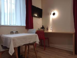 a dining room with a table and a kitchen at La Bâtisse du Velay in Saint-Didier-en-Velay