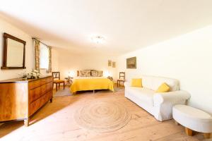 a living room with a couch and a bed at Ferienhaus Nöstlbach in Pittenhart