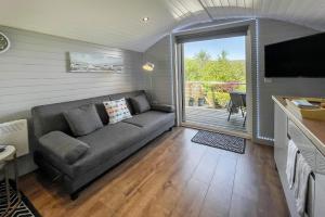 a living room with a couch and a large window at Riabhach in Fort William