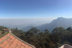 a view of the mountains with a house and trees at Le Rêve Holiday Home in Coonoor +10 photos