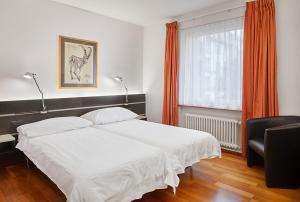 Postelja oz. postelje v sobi nastanitve Hotel du Commerce