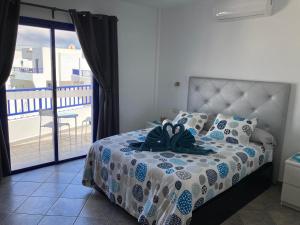 a bedroom with a bed with a view of a balcony at Villa Maria in Playa Blanca +25 photos