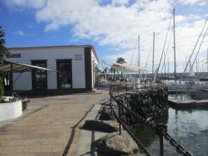 a marina with boats in the water and a building at Villa Maria in Playa Blanca