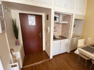 a room with a door and a kitchen with a table at Apartment Tomasović Old Town in Dubrovnik