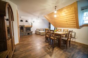 a dining room with a table and chairs and a couch at Tatry Home in Kościelisko