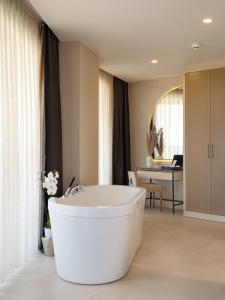 a large white bath tub in a bathroom at Liu Resorts in Side