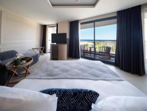 a hotel room with a bed and a large window at Liu Resorts in Side