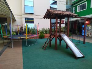 a playground with a slide and a play structure at Hotel Venturim in Venda Nova do Imigrante