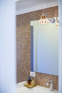 a bathroom with a mirror and a sink at Villa Don Camillo in Sant'Agnello