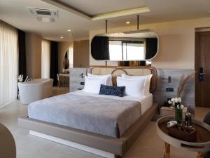 a bedroom with a large bed and a table at Liu Resorts in Side