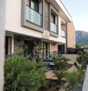 a building with plants in front of it at Casa Mimosa Hotel in Karaburun