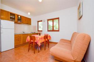 a kitchen with a table and a couch in a room at See view Apartment 2 in Mimice