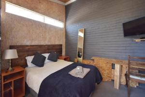 una camera da letto con un letto e una TV a schermo piatto di The Orchid Guesthouse a Bethlehem