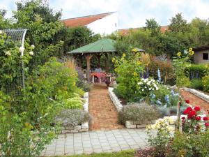 a garden with a gazebo and flowers at Pension Martinus in Neustadt an der Donau