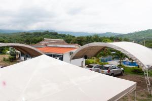 two white tents in front of a parking lot at Santo Domingo Centro Vacacional in Jerusalén