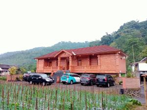 a house with cars parked in front of it at VILLA PRINGGITAN in Karanganyar