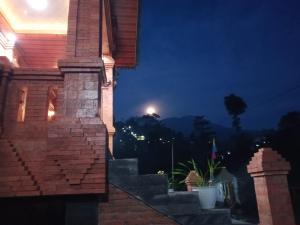 a night view of a house with a moon in the sky at VILLA PRINGGITAN in Karanganyar