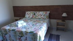 Säng eller sängar i ett rum på Pousada Pedra do Sossego