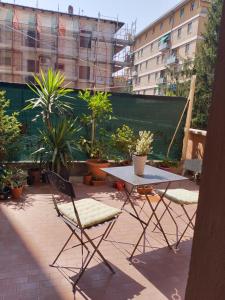 a table and chairs on a patio with plants at M. BINI B&B in Bologna