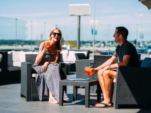 a man and a woman sitting at a picnic table at Grand Jersey Hotel and Spa in Saint Helier Jersey