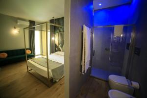 a room with a glass room with a bed and a bathroom at Krysos Luxury Rooms in Agrigento +37 photos