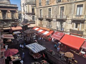 an overhead view of a street with vendors and buildings at Suite On Fish Market in Catania