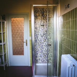 a shower with a glass door in a bathroom at Casa Anna "a lovely home in Tuscany" in Colle Val D'Elsa