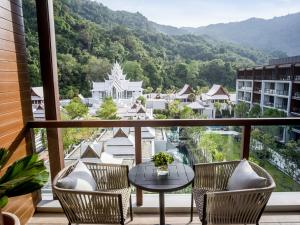 a balcony with a table and chairs and a view at InterContinental Phuket Resort by IHG in Kamala Beach