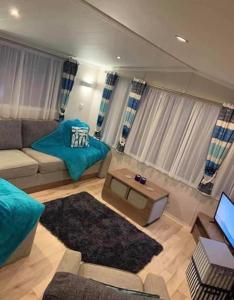 a living room with a couch and a table at 8 Berth,Waterside Leisure,Ingoldmells in Ingoldmells