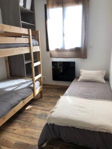 a room with two bunk beds and a window at chalet avec vue lac in Embrun