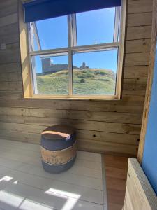 a barrel sitting in a room with a window at The Lobster Shack in Criccieth