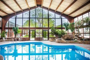 an indoor pool in a building with a large window at The Ingleside Hotel in Waukesha