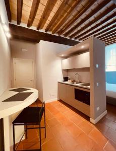 a kitchen with a table and a counter top at Palazzo Borgocolonne Apartments in Parma