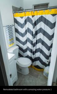 a bathroom with a black and white shower curtain at Tropical Getaway in Aguadilla