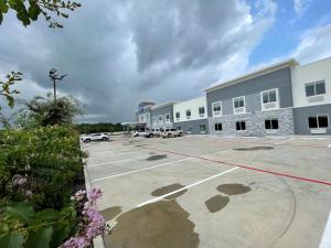 a parking lot in front of a large building at Palace Inn Blue Houston East Beltway 8 in Houston