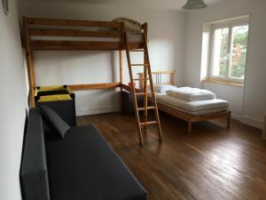 a bedroom with two bunk beds and a ladder at g&icirc;tes au domaine Greiner in Mittelwihr