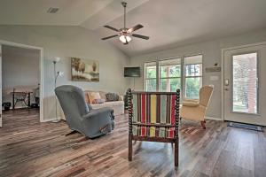 a living room with a ceiling fan and a couch at Relaxing Texas Getaway, 1 Mile to Boat Ramp! in Jefferson