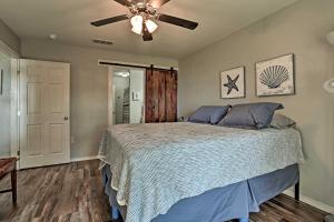 a bedroom with a bed with a ceiling fan at Relaxing Texas Getaway, 1 Mile to Boat Ramp! in Jefferson