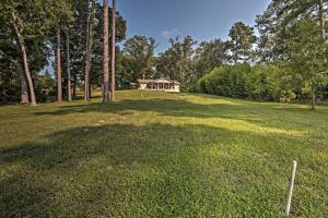 a house in the middle of a grassy field at Relaxing Texas Getaway, 1 Mile to Boat Ramp! in Jefferson