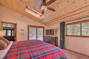 a bedroom with a bed and a ceiling fan at Deck and Yard Family-Friendly Pinetop Retreat in Indian Pine